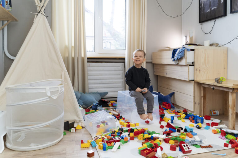 full-shot-smiley-kid-sitting-container